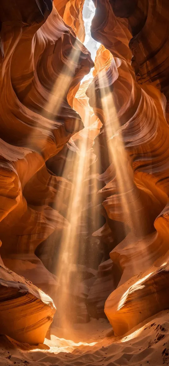 Sunbeams shining down through orange sandstone walls of a slot canyon