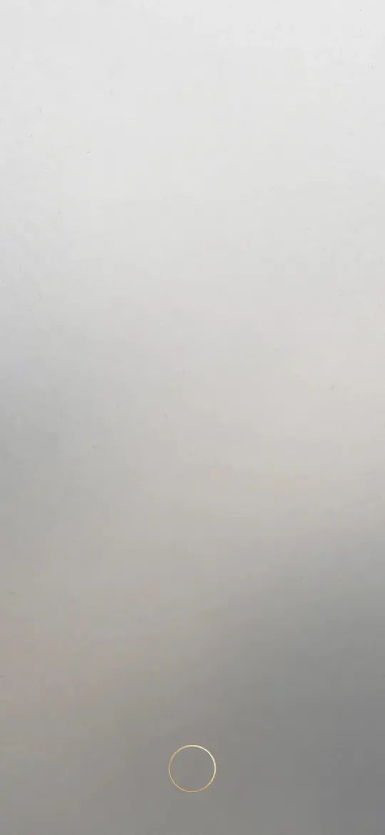 Light grey gradient background with a small thin gold ring near the bottom