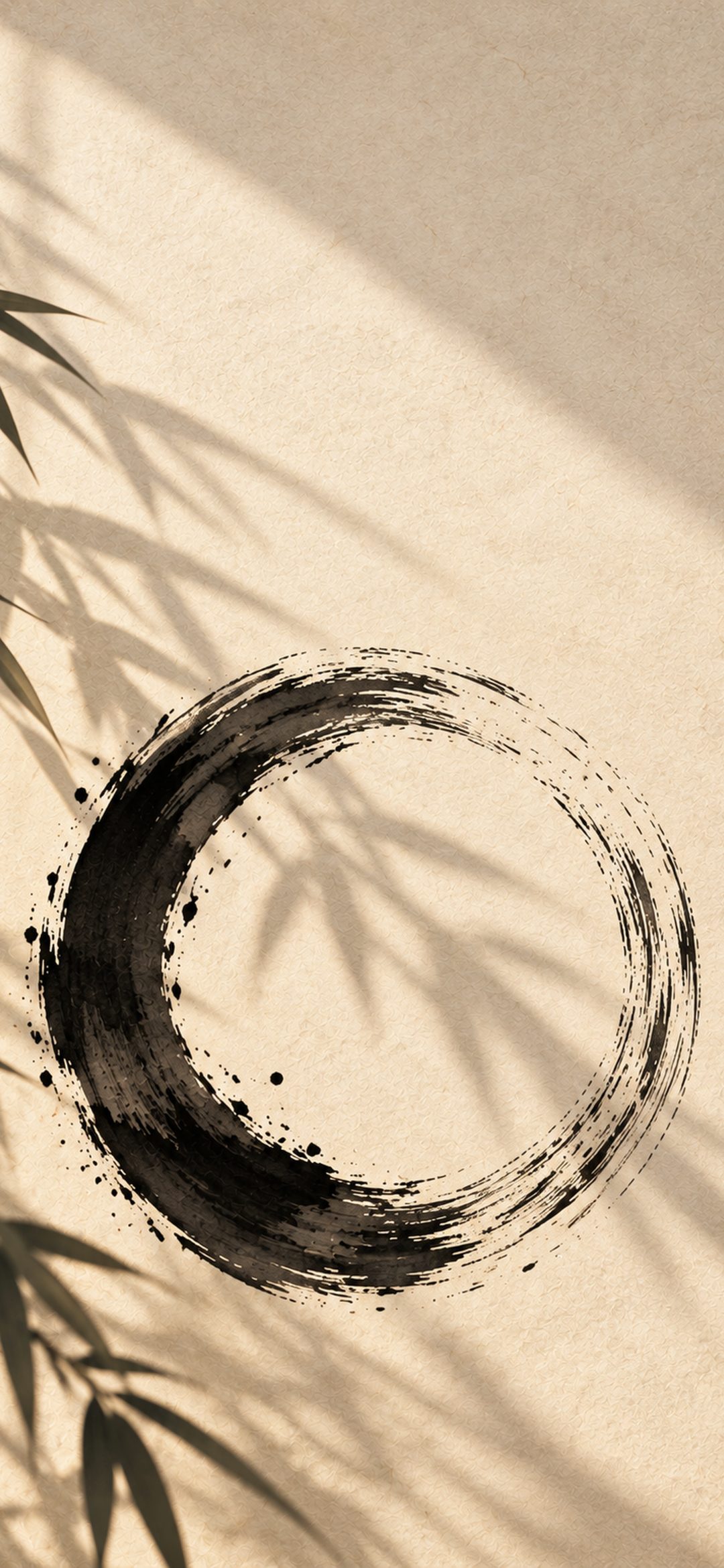 Black ink enso circle on beige paper with soft bamboo leaf shadows