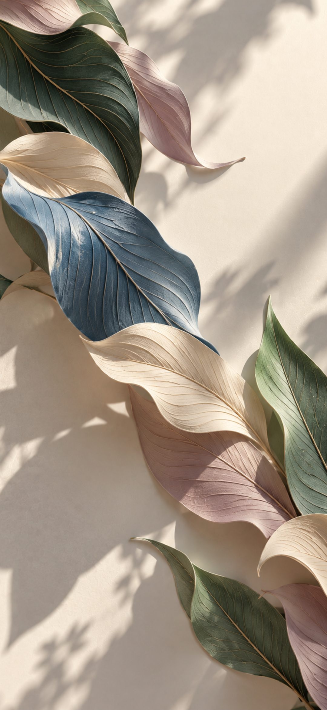 Diagonal row of blue, green, mauve and cream leaves on a sunlit cream wall