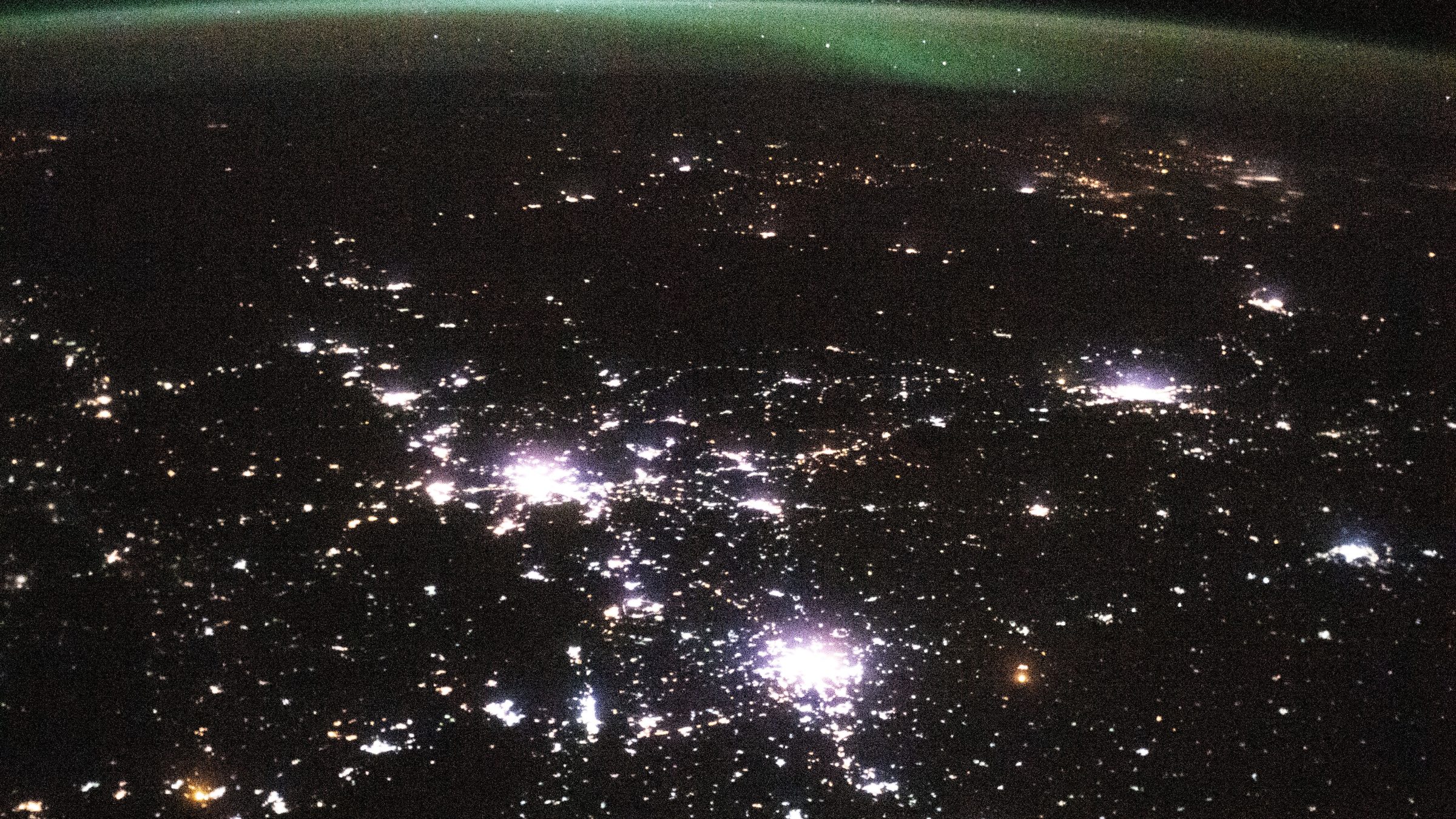 City lights scattered across the dark Earth at night, seen from space