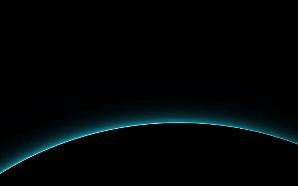 Cyan Dawn Horizon: a sliver of cyan dawn light lines the curved edge of a dark world, its glowing atmosphere fading upward into black space, Mac wallpaper