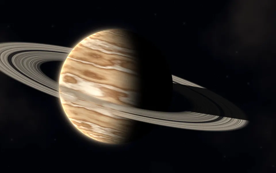 Gilded Ring Planet: a golden ringed gas giant fills a wide starry sky, its bands of cream and ochre lit from one side and shadowed on the other, Mac wallpaper