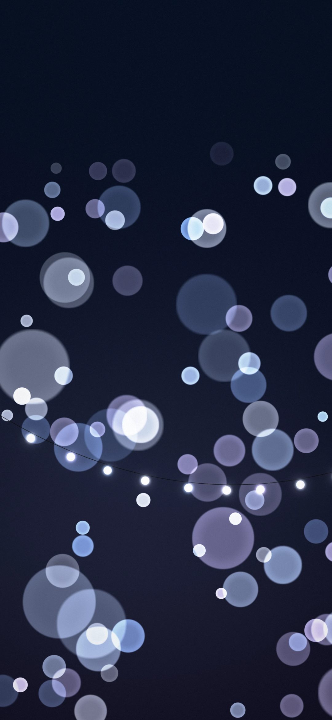 Icy Twinkle Lights: cool white and pale blue fairy bulbs hang on a thin wire while lavender and ice blue bokeh circles drift through a deep navy winter night, iPhone wallpaper