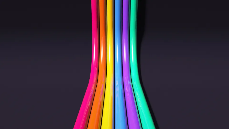 Neon Tubes After Dark: pink, orange, yellow, blue, purple and green glossy tubes run across a dark studio and rise up its curved back wall, PC wallpaper