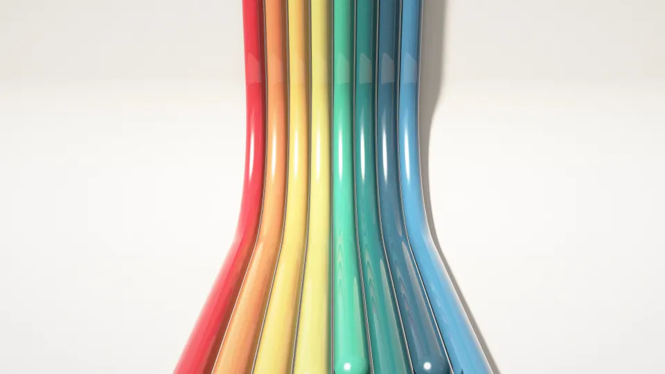 Primary Pipes Climb: eight glossy tubes in red, orange, mustard, teal and navy run across the floor and curve up the wall of a white studio, PC wallpaper