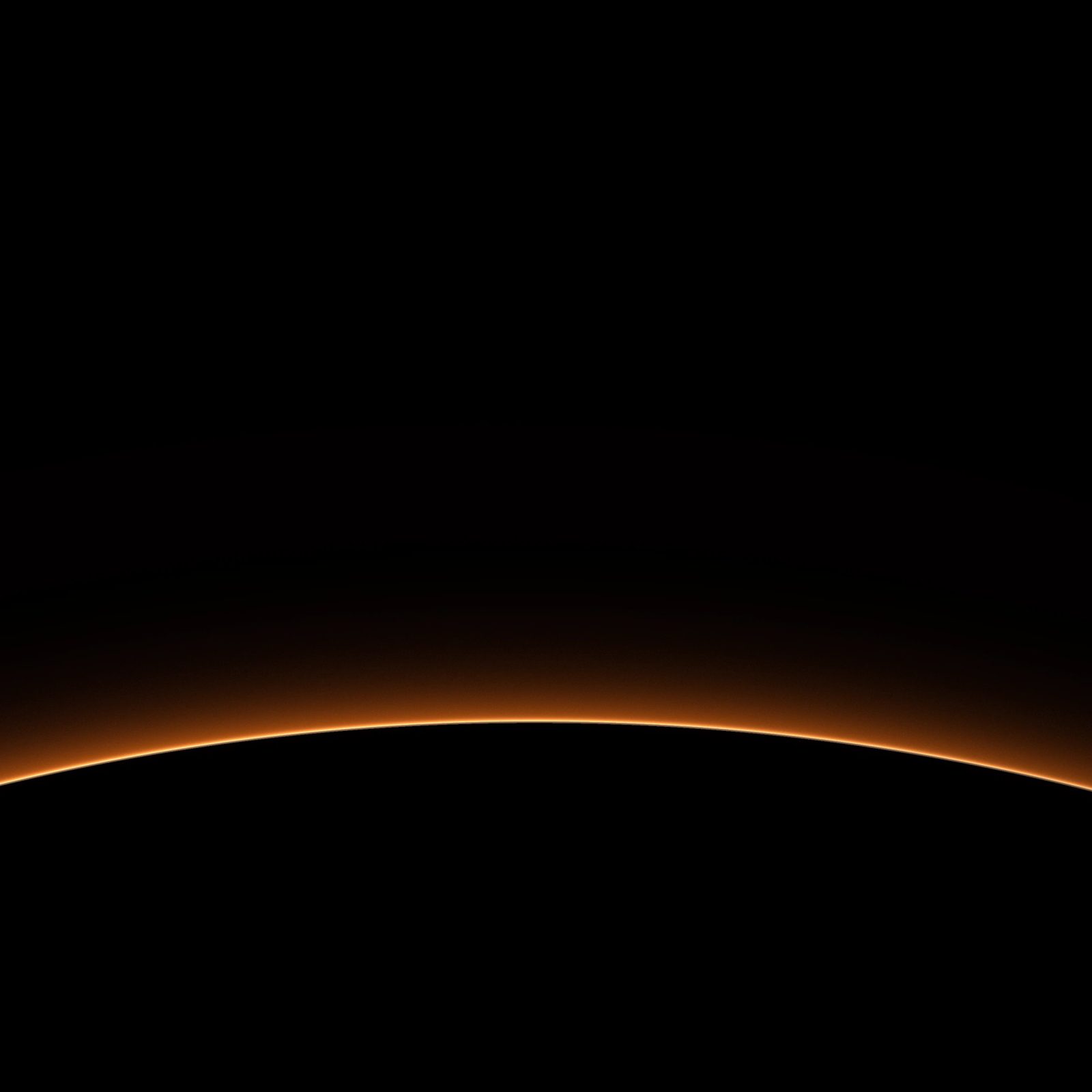 Red Planet Rim: a thin orange rim of light outlines the edge of a dark planet, warm haze rising softly into the surrounding black, iPad wallpaper