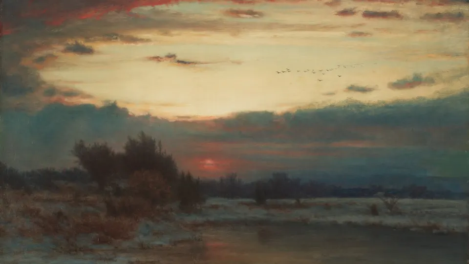Red sun setting over a flat winter marsh with bare trees