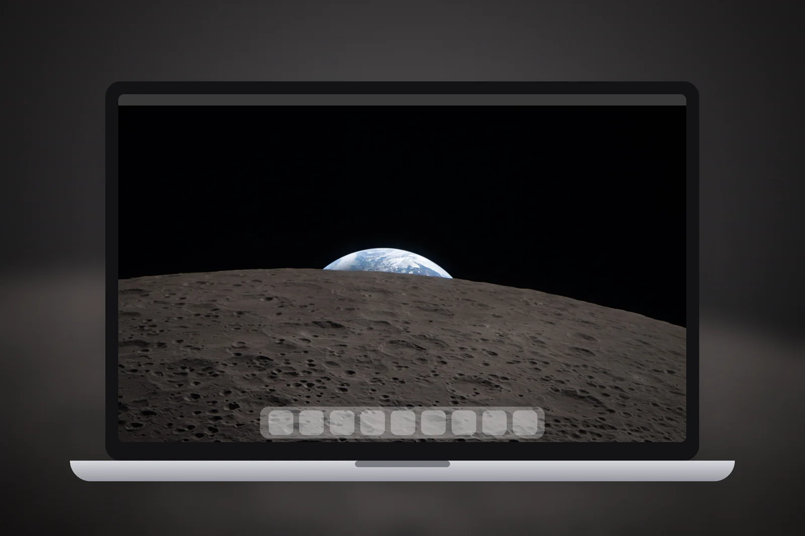A Mac laptop showing the Earthset Over the Moon wallpaper on its desktop
