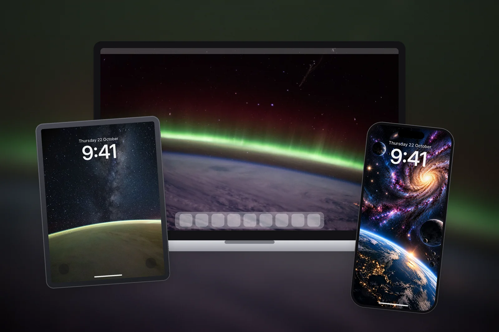 A Mac, an iPad and an iPhone with the matching Green Aurora Arc, Milky Way Above Earth and Space Galaxy wallpapers